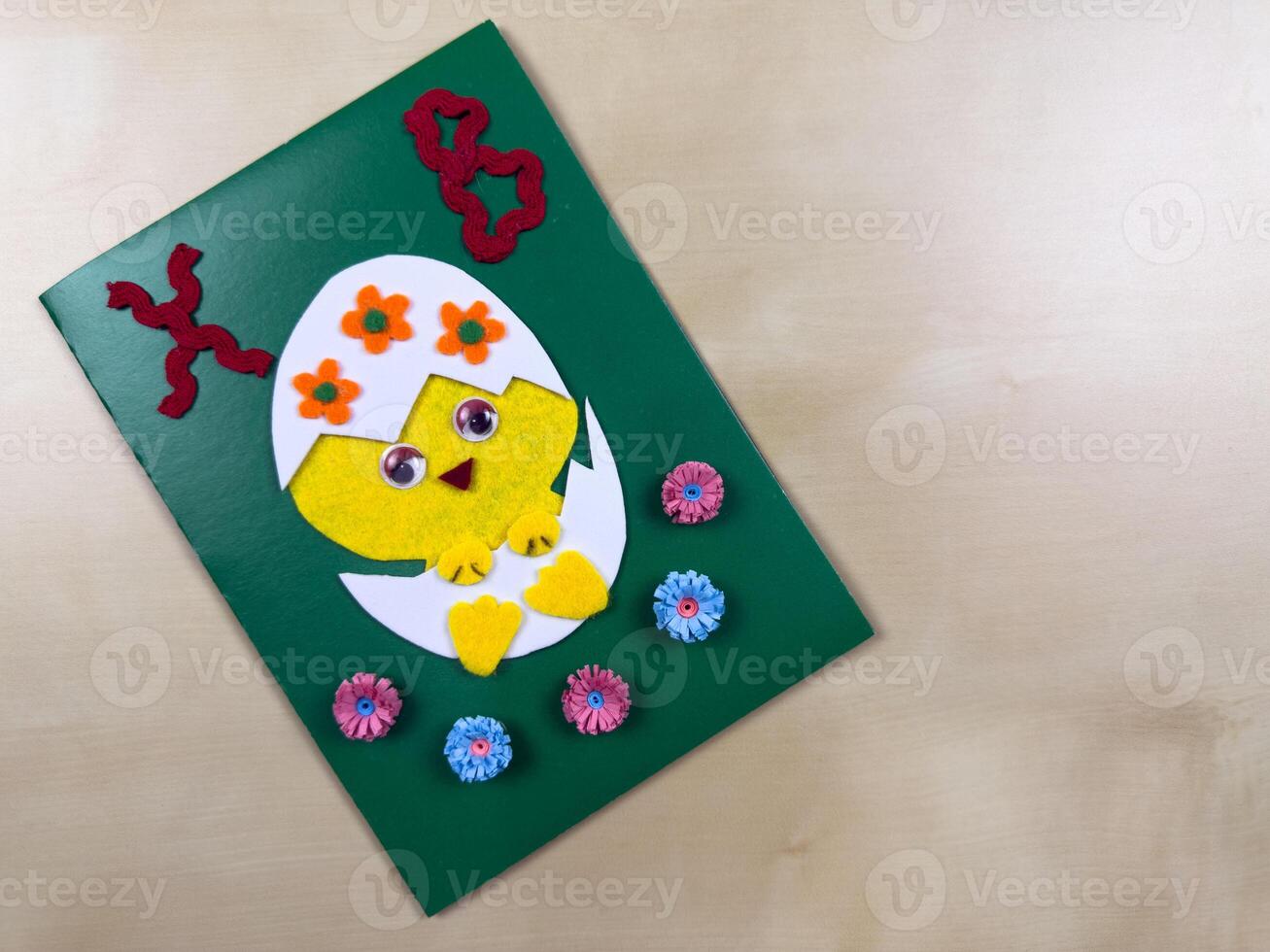This delightful handmade Easter card features a cute chick emerging from an egg, adorned with colorful flowers. Perfect for sending warm wishes and spreading joy during the holiday season photo