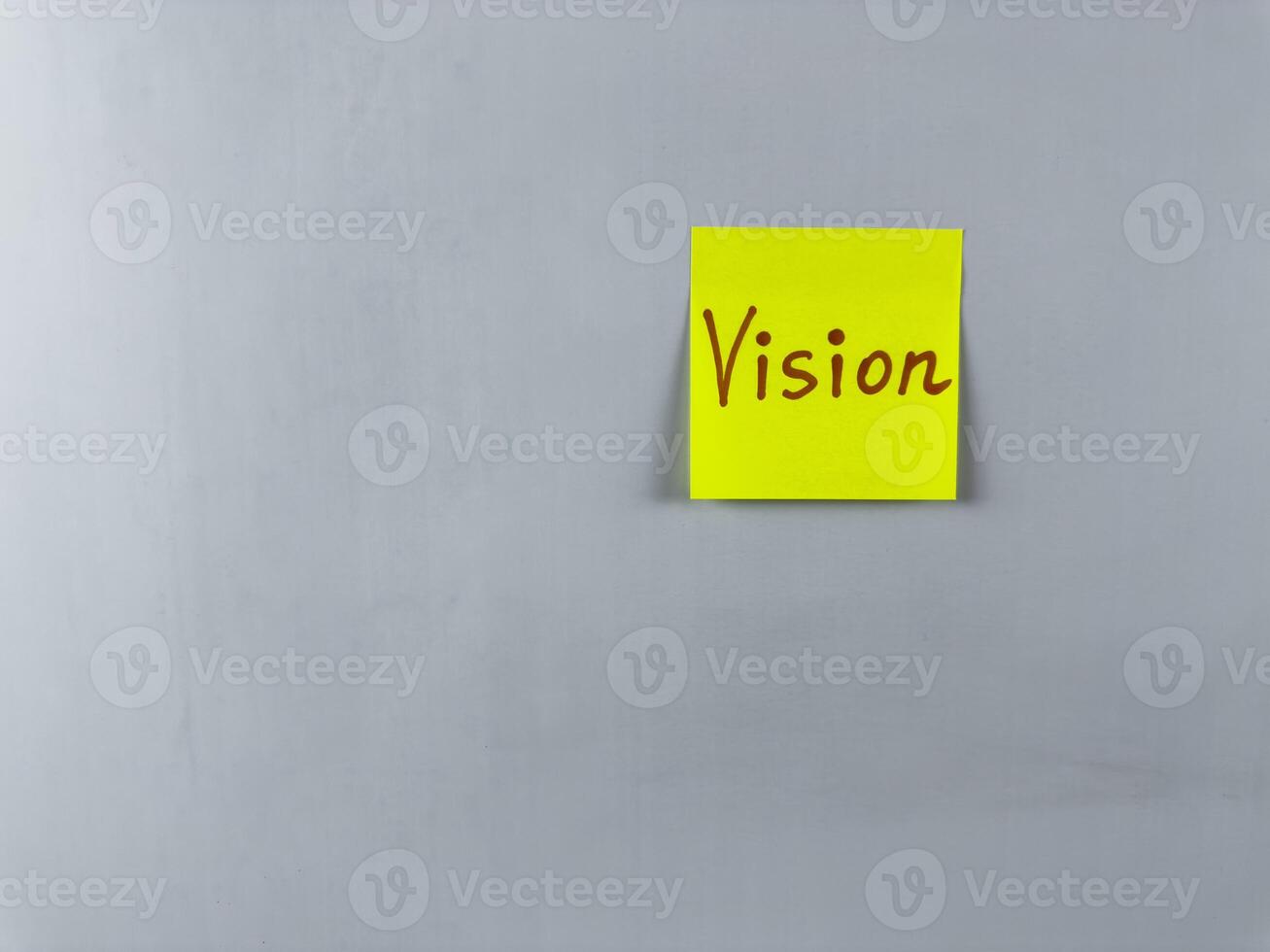 Sticky note with the word Vision written on it, placed on white background. Ideal for illustrating themes of foresight, goals, and inspiration. Great for concept creation photo