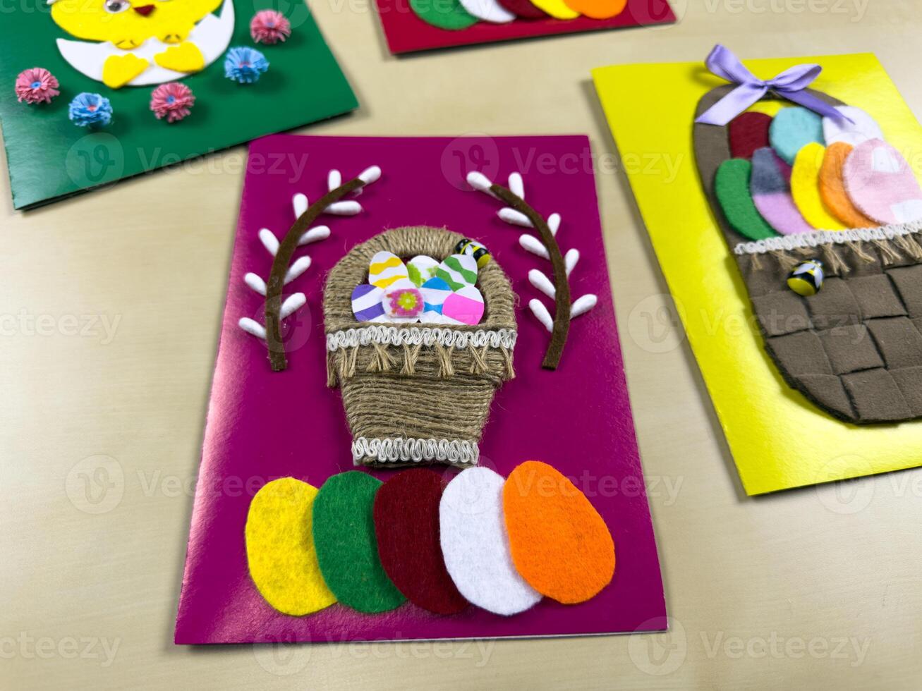Delightful handmade Easter card showcases charming basket filled with vibrant felt eggs. Perfect for sharing joy and warm wishes during Easter celebrations with loved ones photo