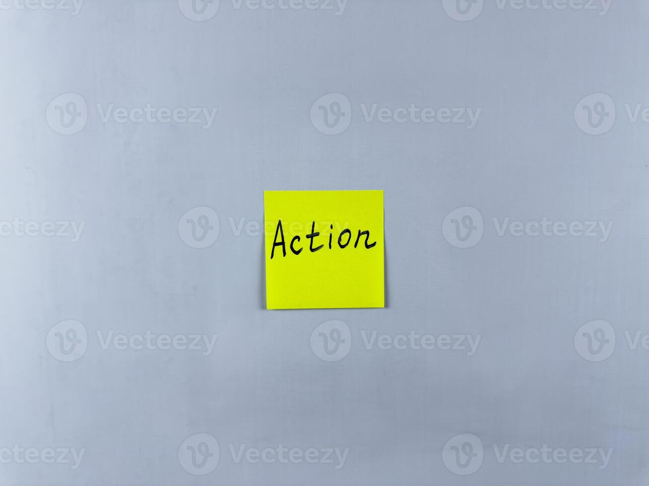 Sticky note with the word Action written on it, placed on white background. Ideal for illustrating themes of initiative, movement, and productivity. Great for concept creation photo
