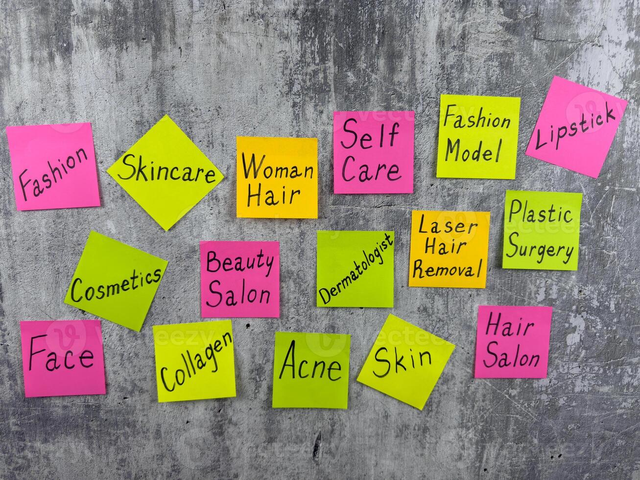 Multicolored sticky notes with words about beauty and fashion industry. Reminder about the importance of selfcare and skin care. Dermatology and hair care with inscriptions on the wall photo