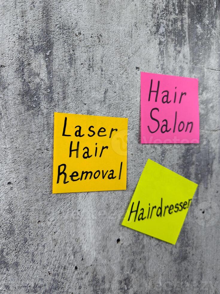 Sticky note with the inscription Laser Hair Removal. Reminder to visit specialist for laser hair removal on the body. Laser hair removal concept for skin care photo