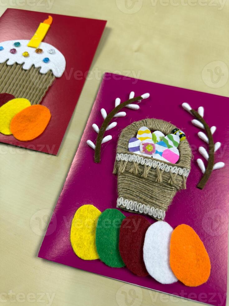 Delightful handmade Easter card features jute basket adorned with vibrant felt eggs and cheerful decorations. Ideal for sharing warm wishes and enhancing festive spirit during Easter celebrations photo