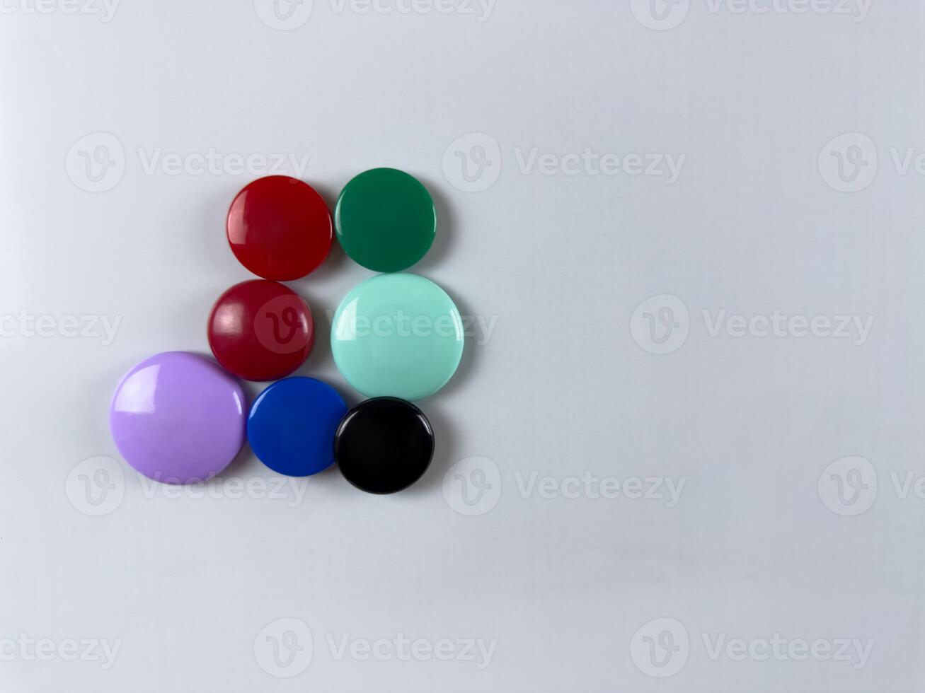 Group of magnets on whiteboard. Perfect for attaching notes and reminders. Enhancing organization and planning in office school or home settings. Organization of personal time photo