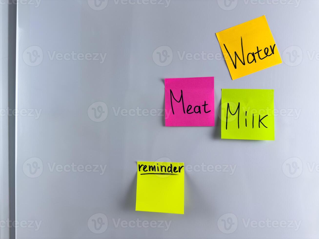 Reminder on colored sticky note hangs on refrigerator photo