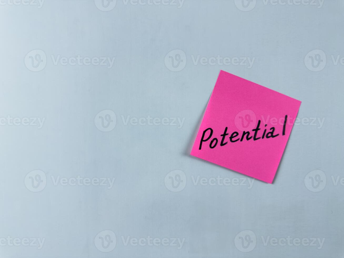 Sticky note with the word Potential written on it, placed on a white background. Ideal for illustrating themes of capability, growth, and opportunity. Great for concept creation photo