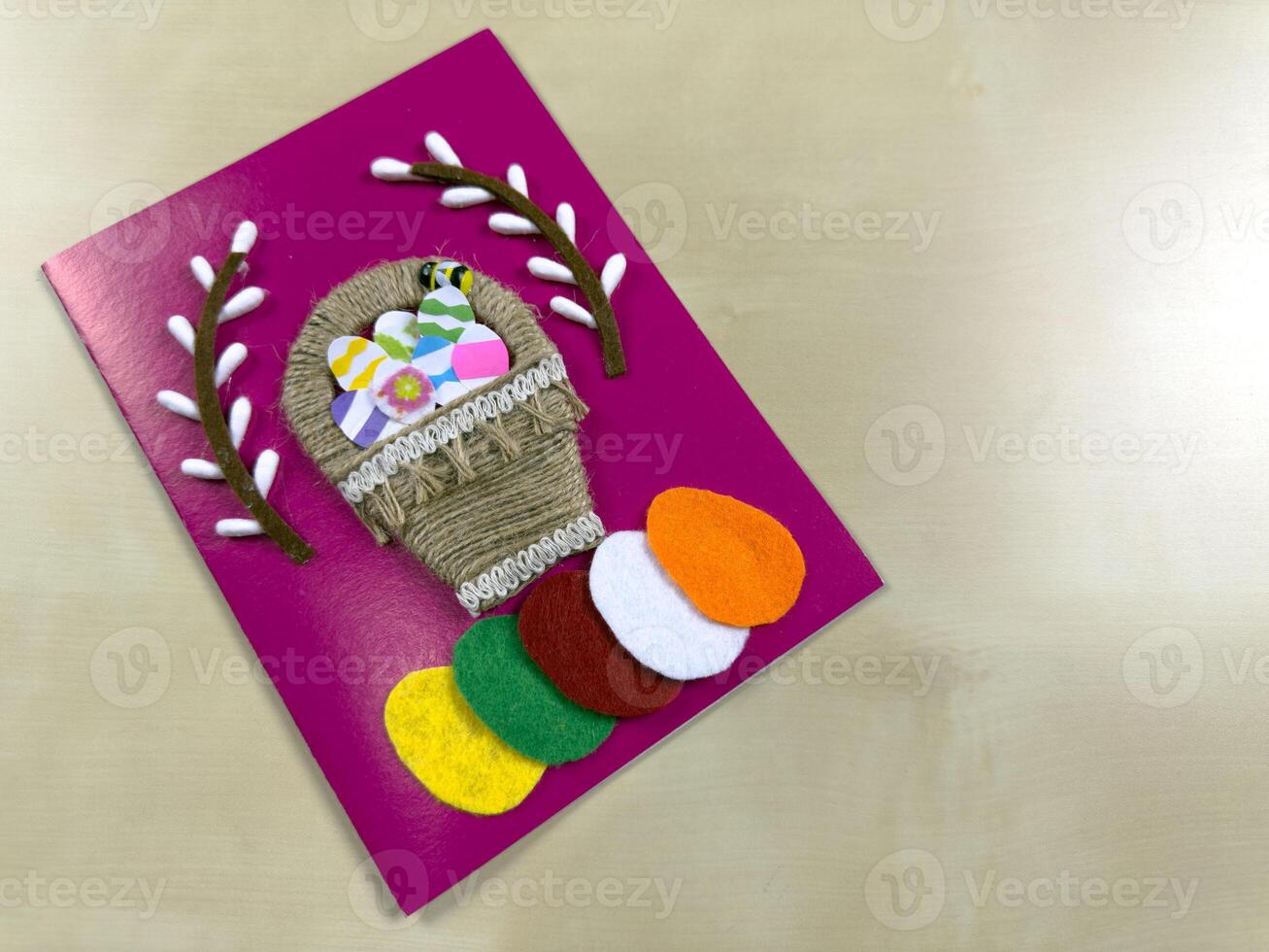 Delightful handmade Easter card features charming basket filled with colorful felt eggs and willow. Perfect for spreading joy and warm wishes during the Easter holiday season photo