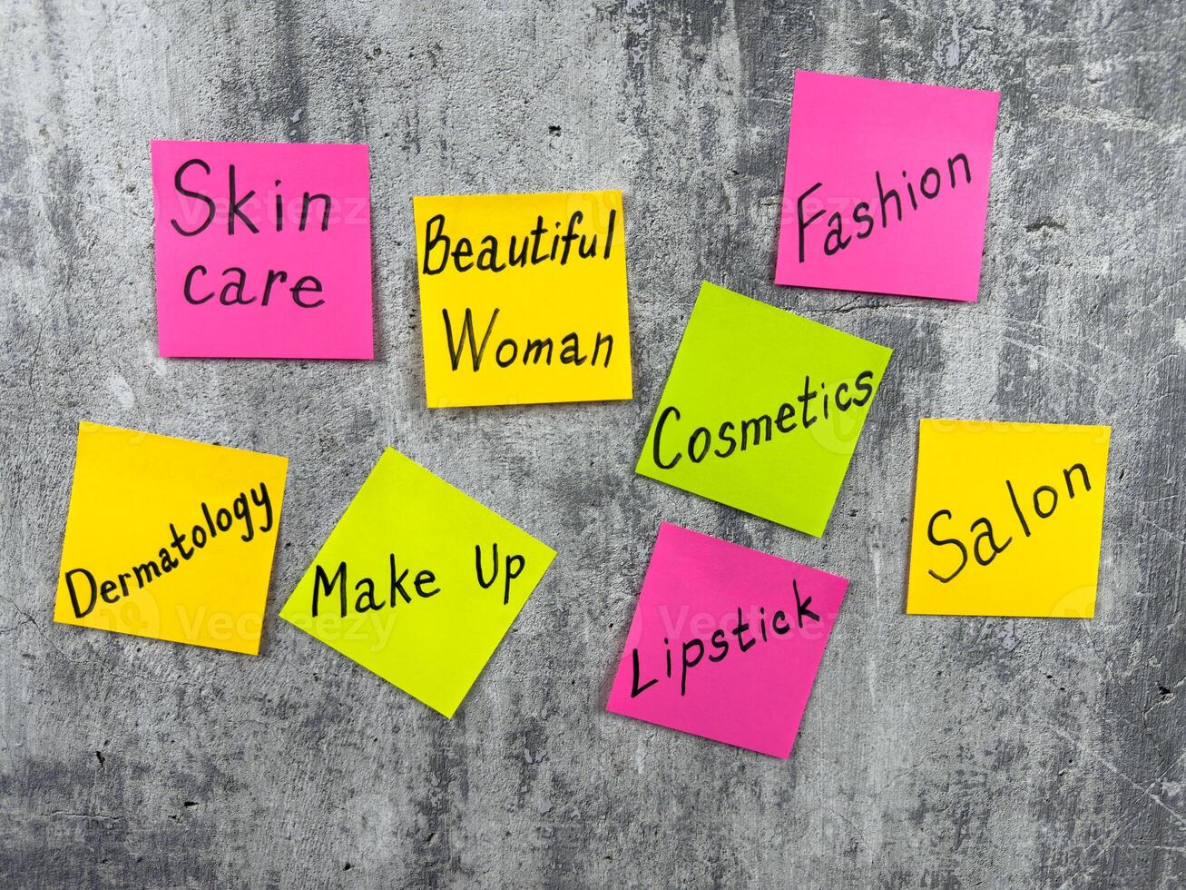 Cosmetic concept for fashion industry with simple design with stickers and words about makeup components. Attractiveness of girl and creating image with help of cosmetics and emphasizing her face photo