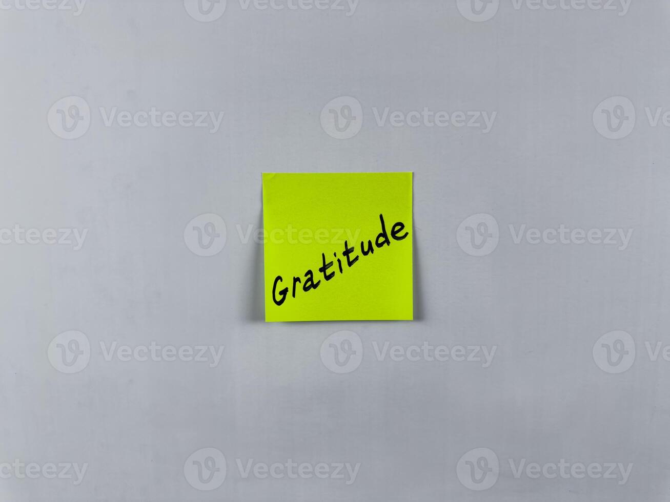 Sticky note with Gratitude written on it, affixed to white background. This image represents thankfulness and appreciation, ideal for themes of gratitude and positivity photo