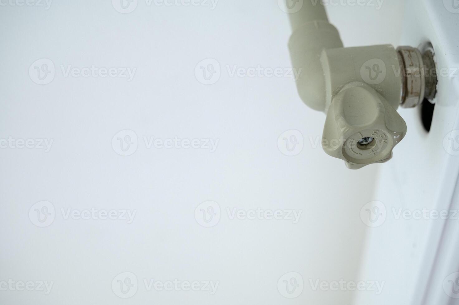 close-up of a plastic valve that fits into the heating system. pipe and radiator with a heating system photo