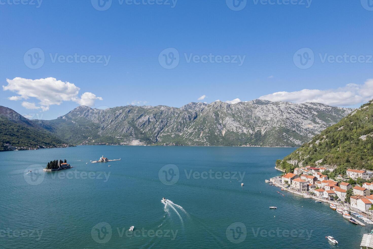 Motor boat sails along the Bay of Kotor to the island of St. George. Montenegro. Drone photo