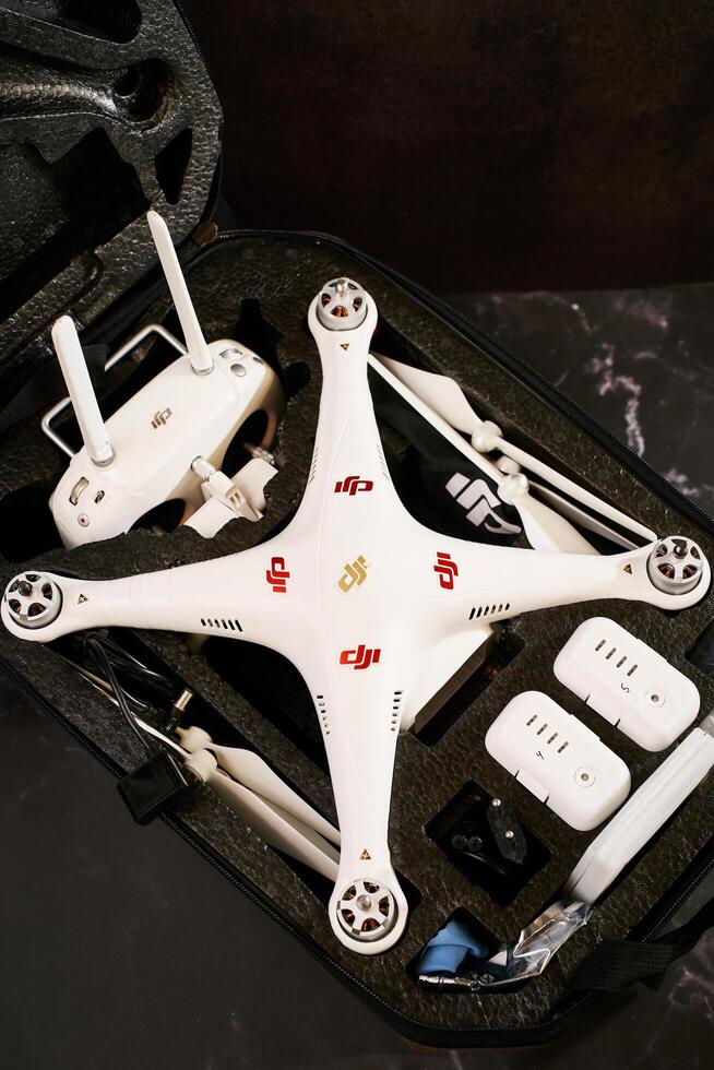 USA, Arizona - March 10, 2025. Complete set of DJI Phantom Professional drone with spare parts lies in a protective case on a black table photo