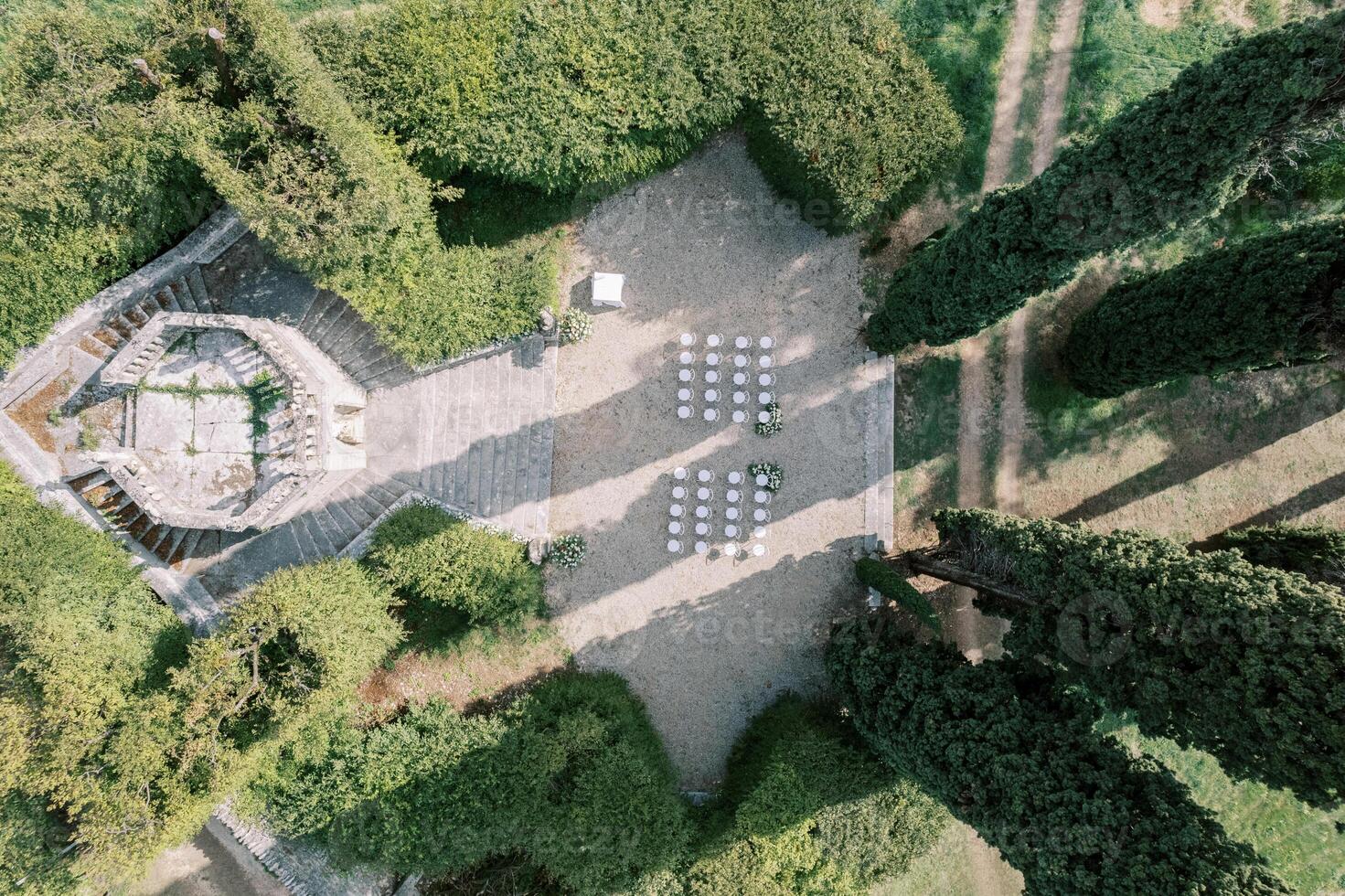 Chairs stand in the garden surrounded by high hedges near the observation deck. Drone photo