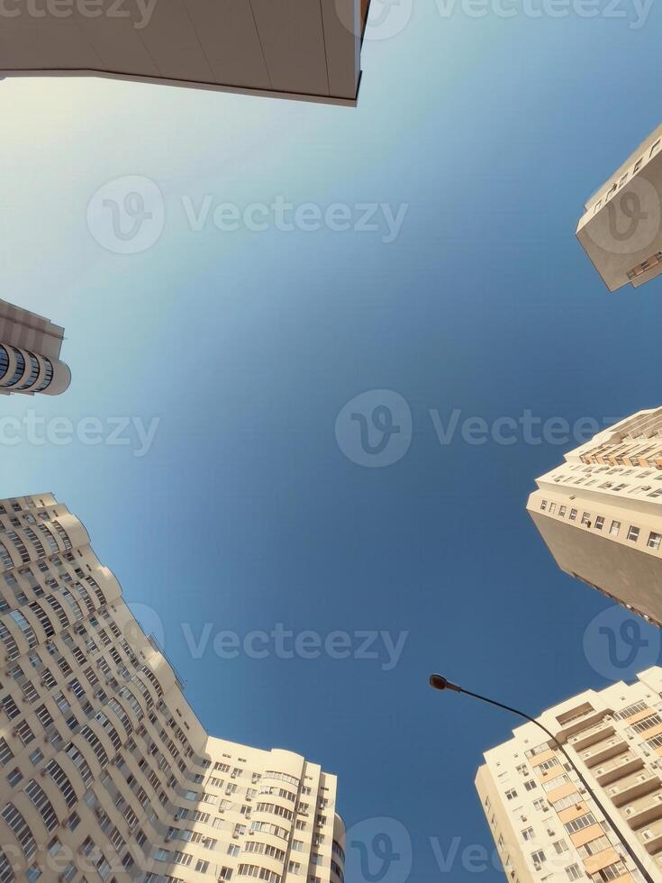 Skyward view of modern architecture capturing the essence of urban life during a sunny day photo