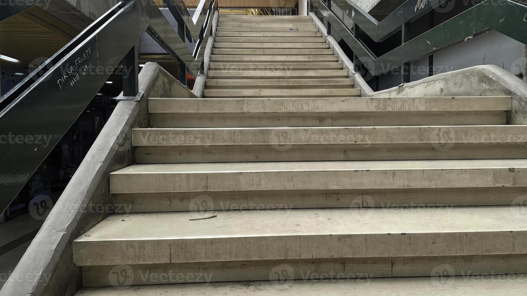 Steps leading to higher levels in an urban shopping area during a bright sunny day, inviting exploration and discovery of stores photo