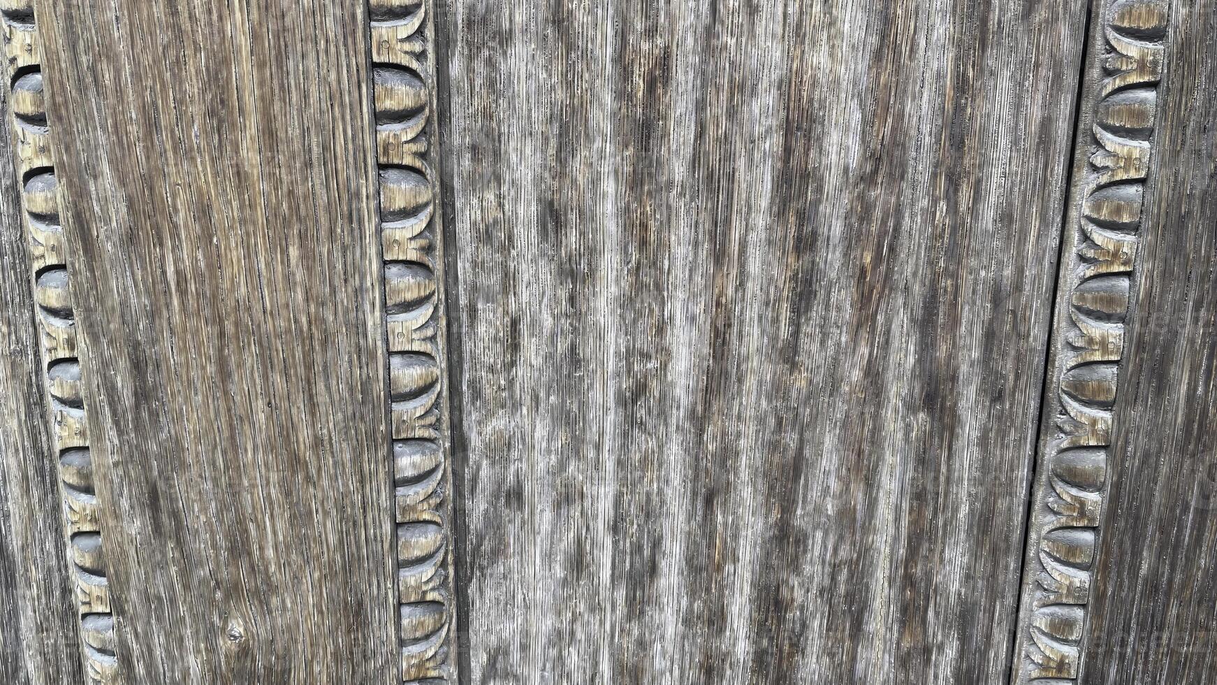 Craftsmanship shines in aged wood texture showcasing intricate carvings from a historic artistic movement photo