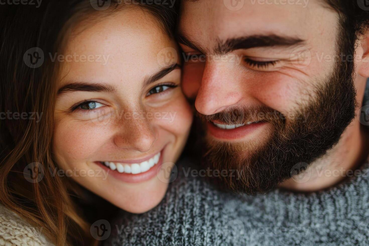 Young couple sharing a joyful moment together while smiling and enjoying each other's company in a cozy setting photo