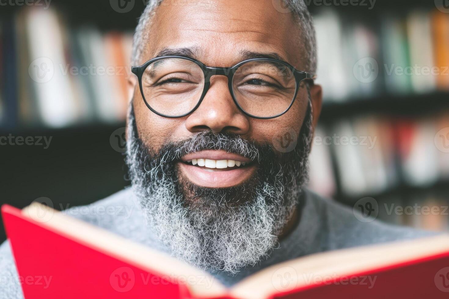 Enjoying a captivating book while smiling in a cozy library setting with shelves full of books in the background photo