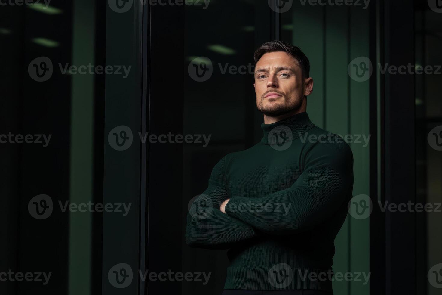 Confident man poses in a sleek urban setting during evening hours with modern architecture and soft lighting photo