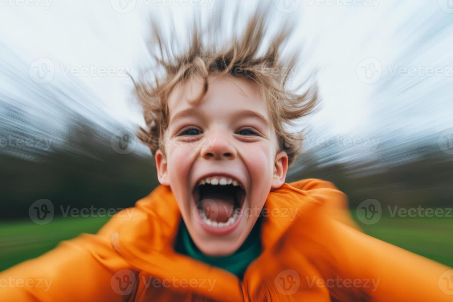 Joyful child running outdoors with wind-blown hair in a vibrant orange coat on a cloudy day,motion blur photo