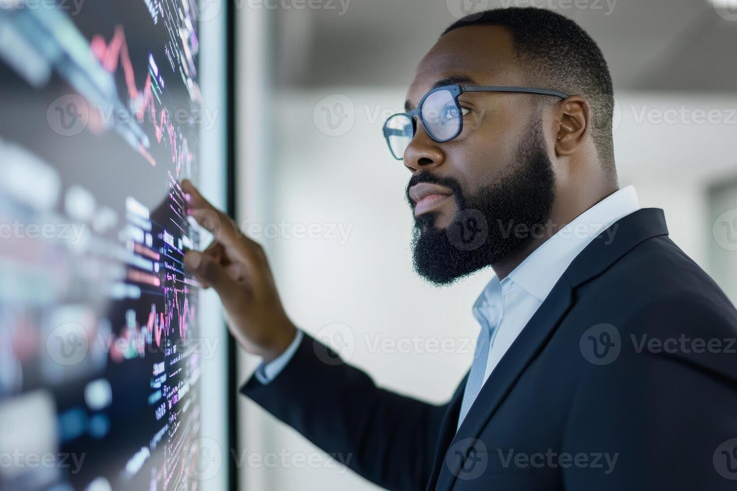 Professional man analyzing financial data on a digital display in a modern office setting photo