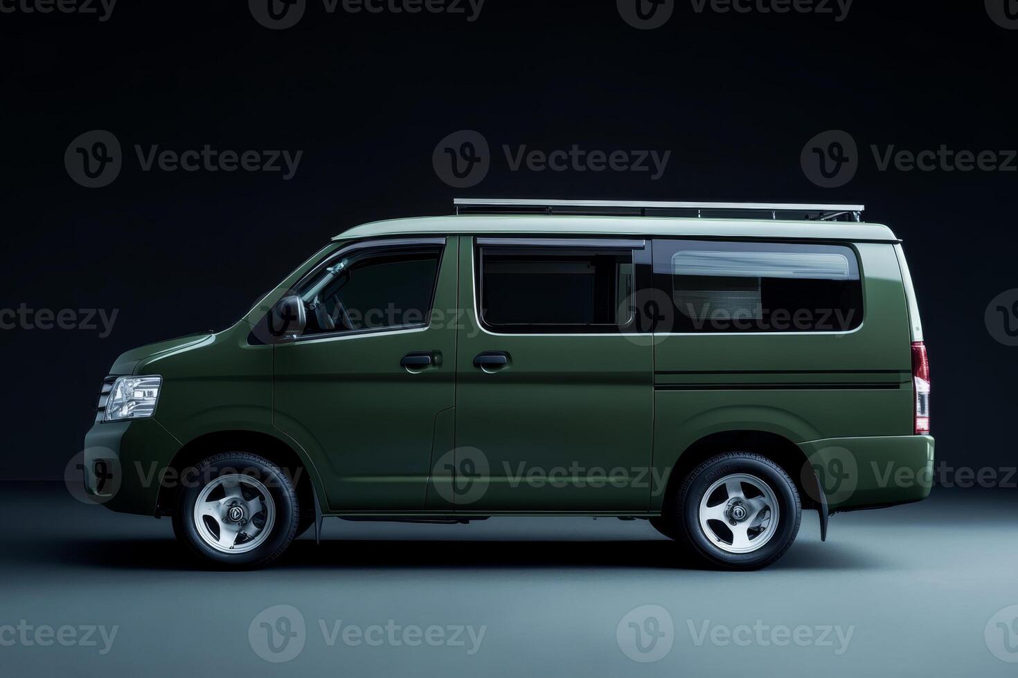 Green van parked in a dark studio, showcasing its sleek design and modern features, ideal for adventure and travel enthusiasts photo