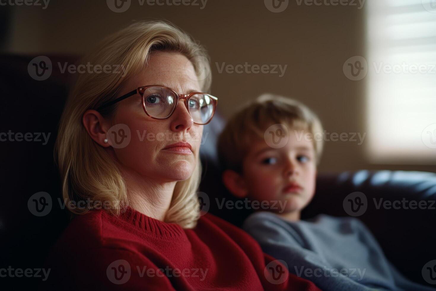 Mother and child sharing a quiet moment at home during a relaxed afternoon on the couch photo