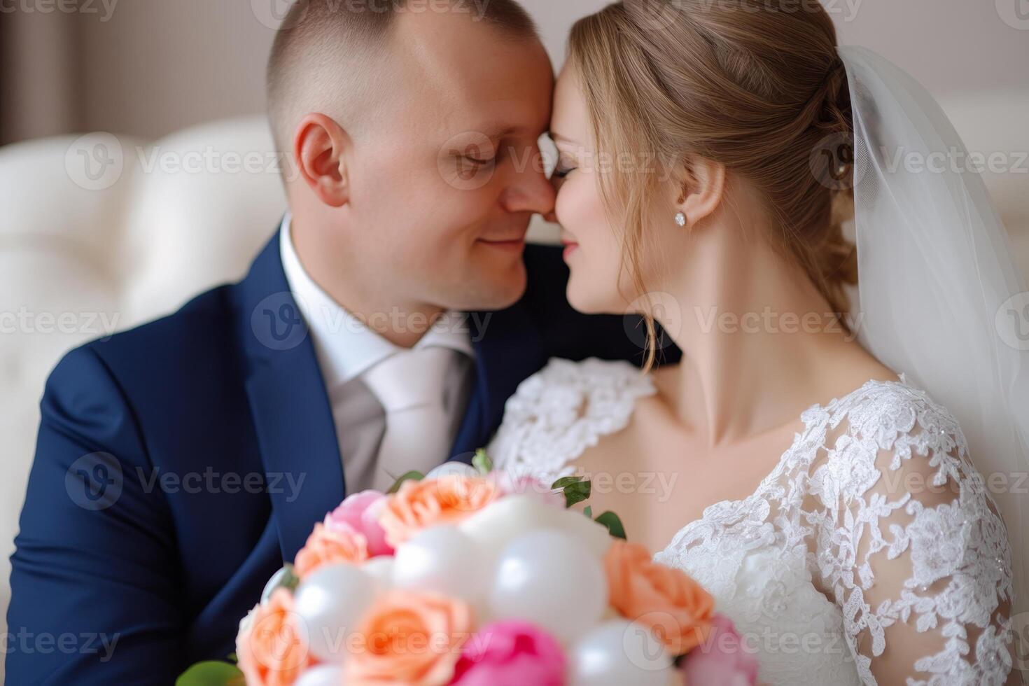 Newlywed couple embraces in a soft moment, gazing into each other's eyes while holding a bouquet of vibrant flowers, radiating love on their special day photo