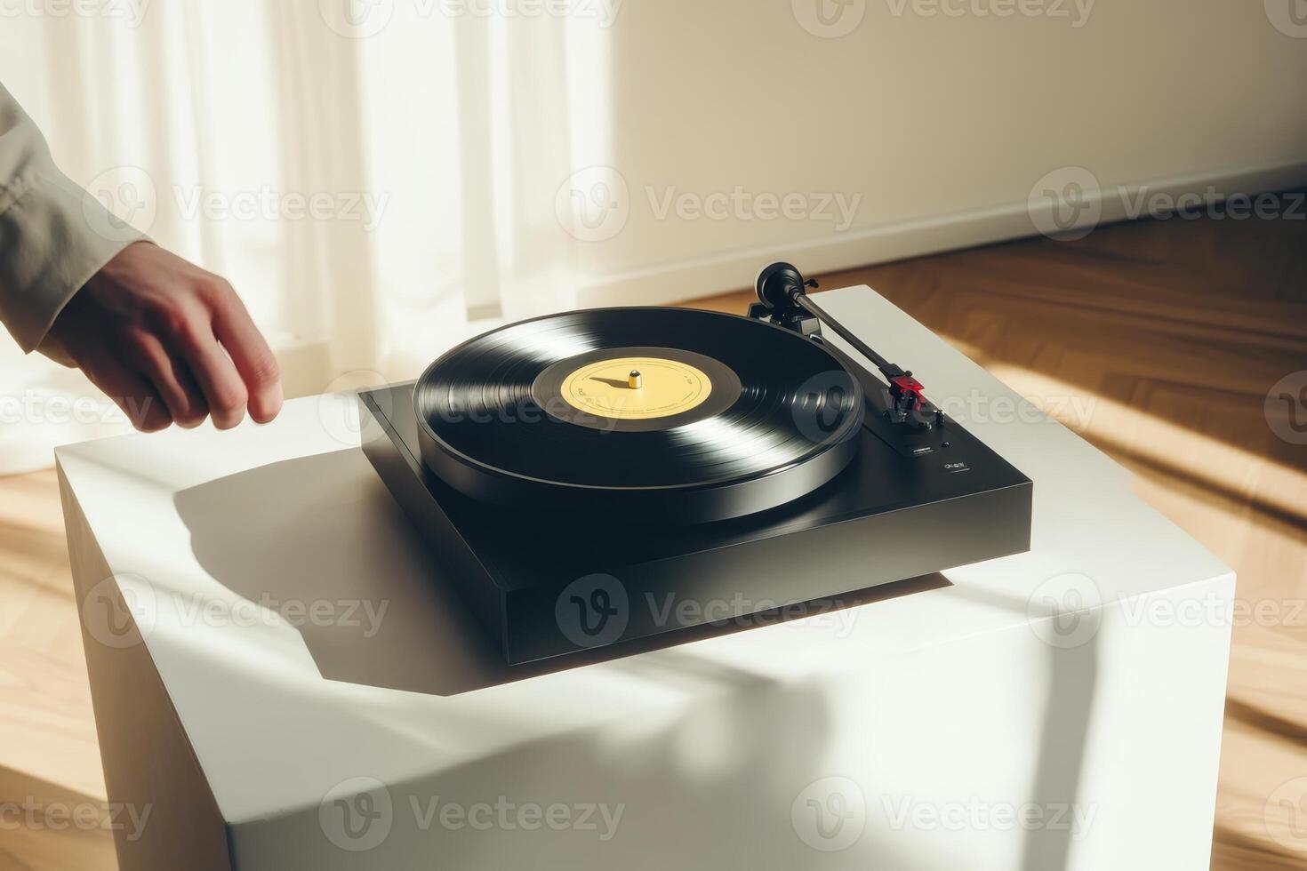 Elegant hand reaching for a vinyl record on a turntable in a sunlit room photo