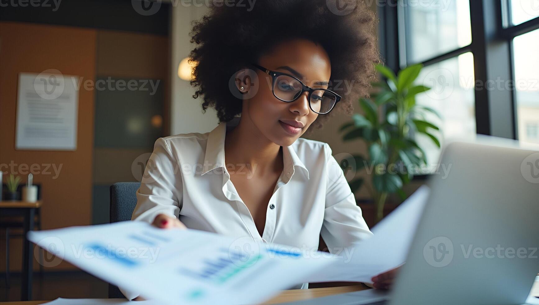 Young African American Business Woman as Account Manager Reviewing Financial Reports on Laptop with Enterprise Software in a Modern Office Flat Illustration for Professio Realistic Set photo