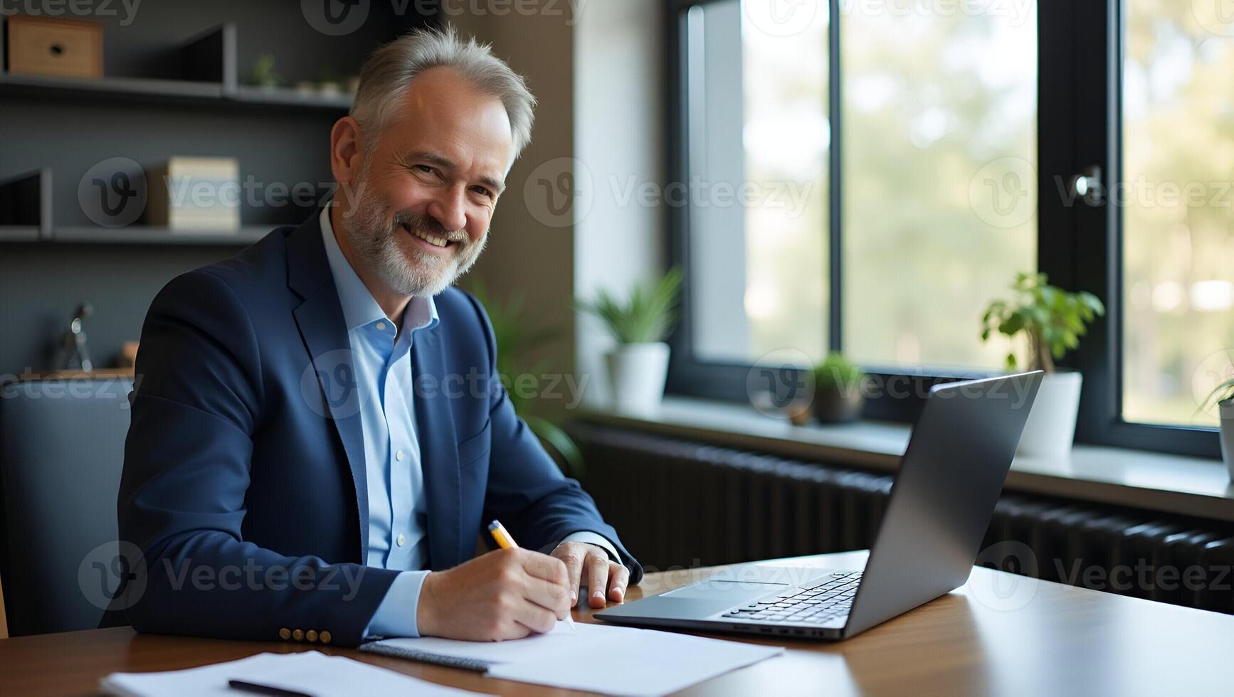 Middle aged smiling professional businessman and CEO wearing suit sitting at desk in modern office working on laptop and writing notes with copy space for text concept as Middle a Realistic Set 2 photo