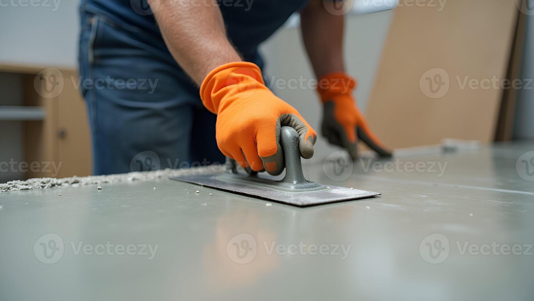 Close Up Action Shot of Construction Worker in Orange Gloves Smoothing Concrete Floor with Trowel Perfect Photo Stock Concept with Empty Space for Text on Left Side Realistic Set