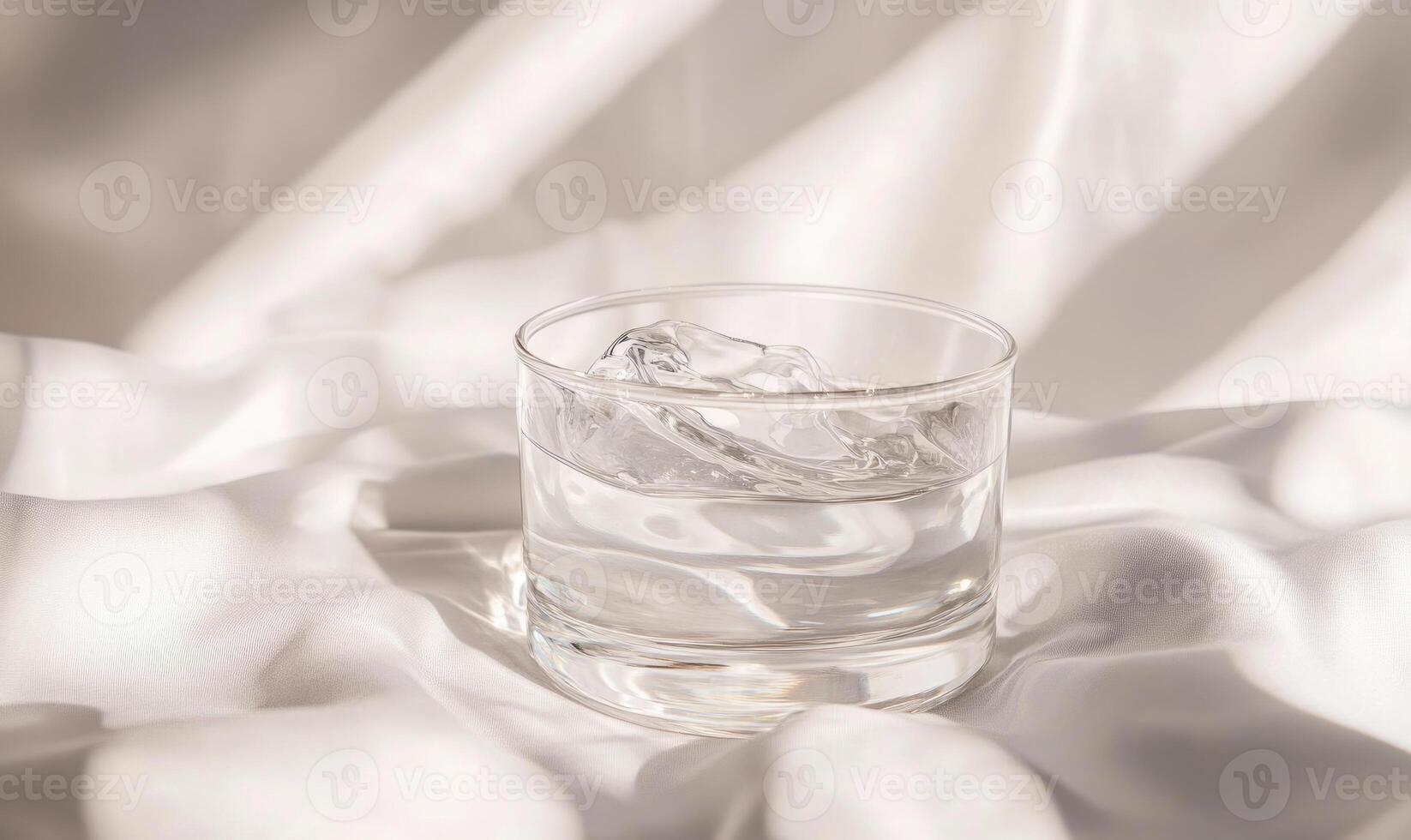 A glass of water with ice cubes in it. photo