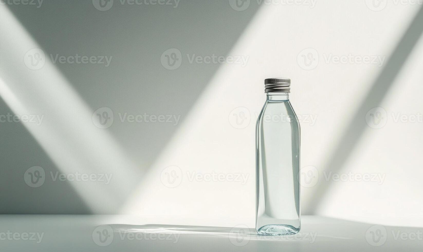 A clear bottle of water sits on a table. photo
