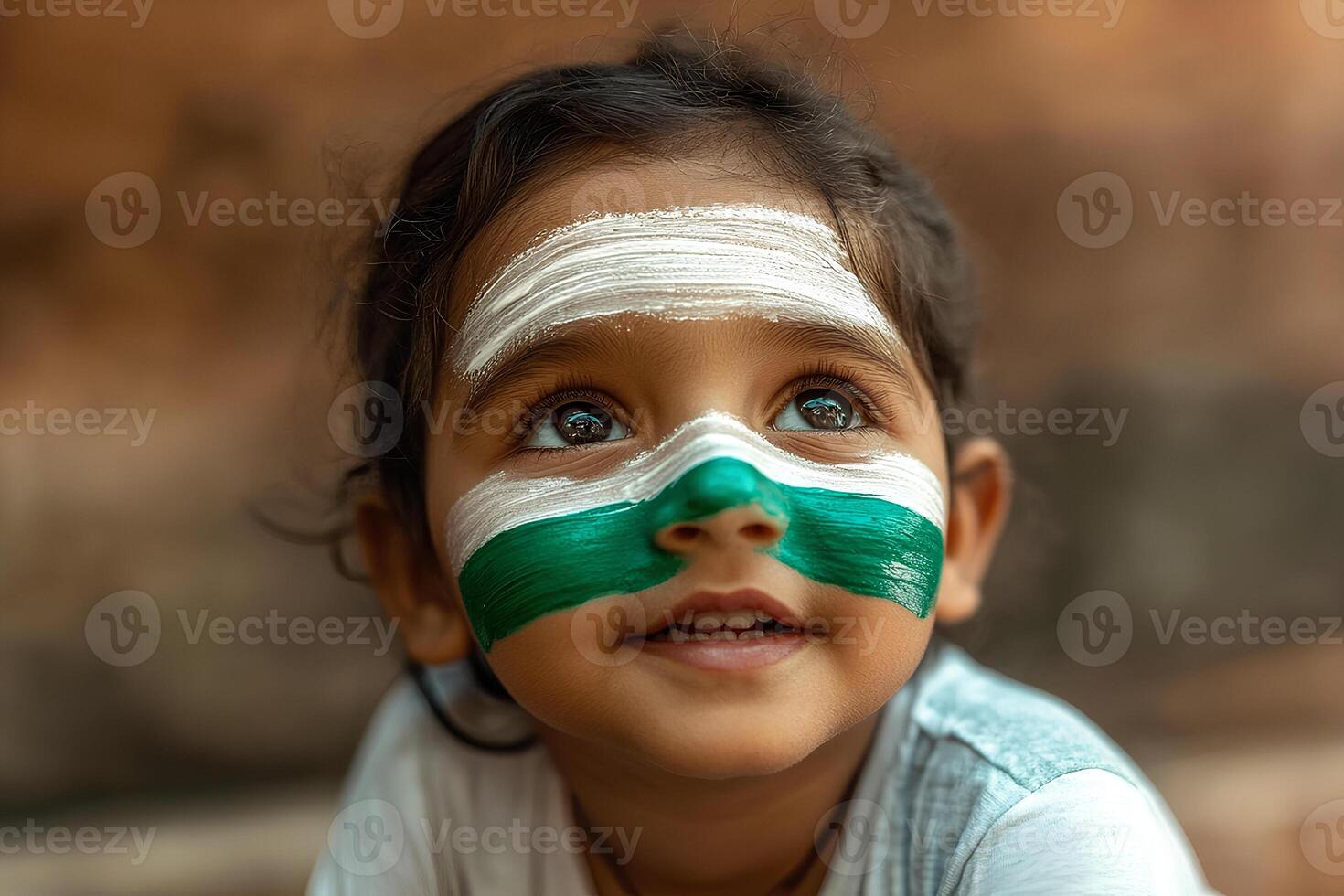A portrait of a little Indian girl with the Indian flag painted on her face, expressing pride and joy, showcasing a sense of cultural identity and patriotism photo