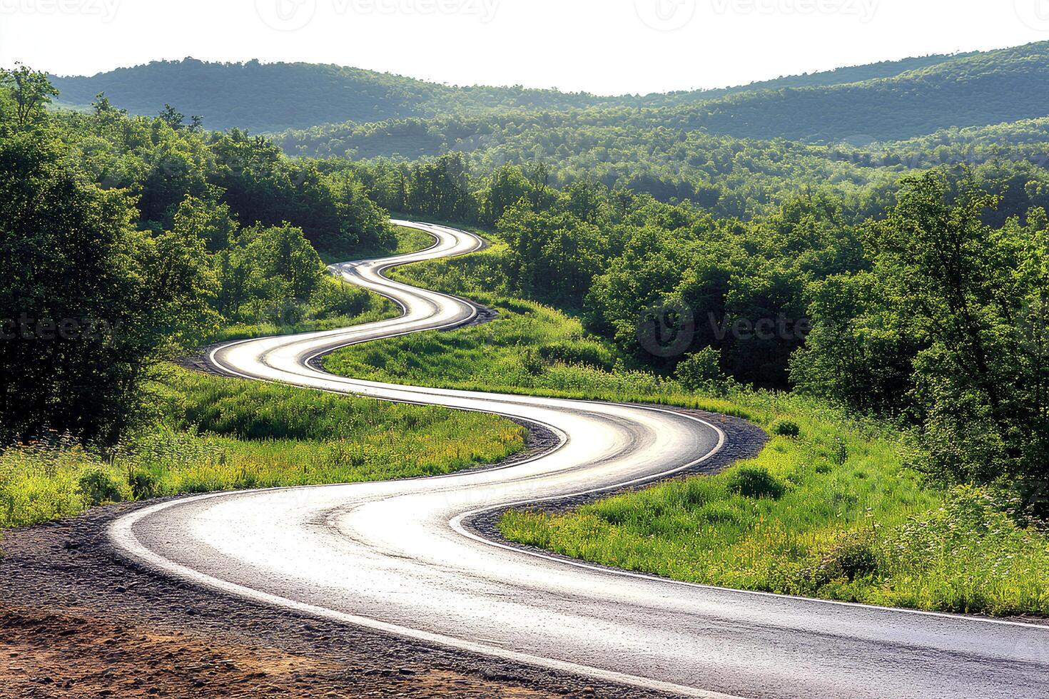 Scenic landscape featuring an asphalt road winding through the mountains, surrounded by natural beauty and rugged terrain photo
