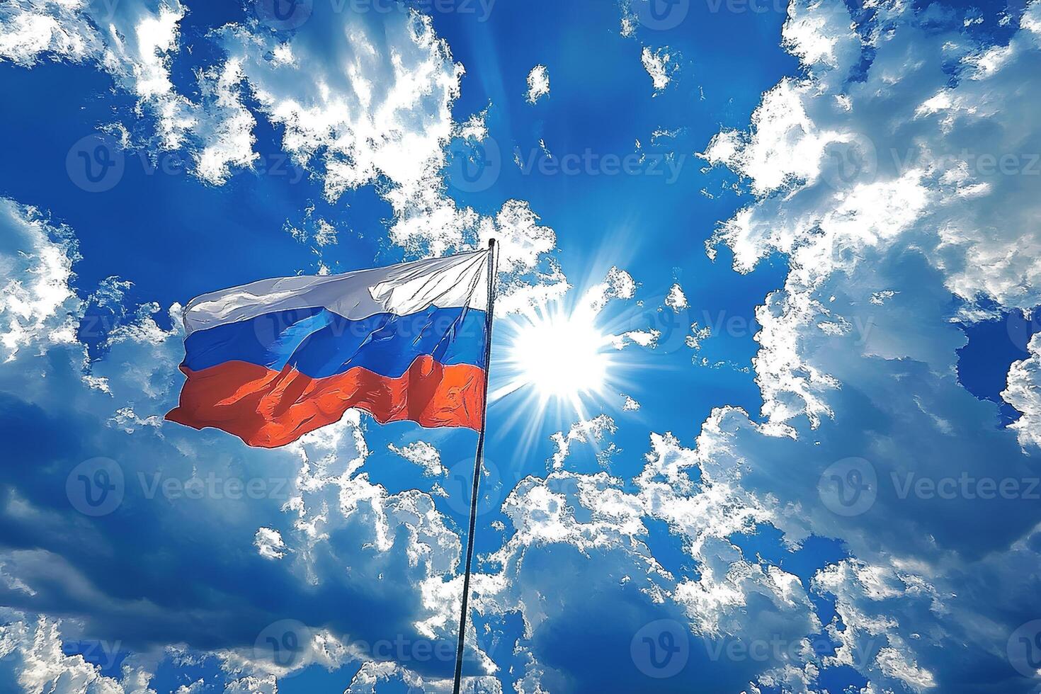 The Russian flag proudly waves in the breeze against a bright blue sky, with the sun shining in the background. The vibrant colors of the flag contrast beautifully with the clear sky. photo