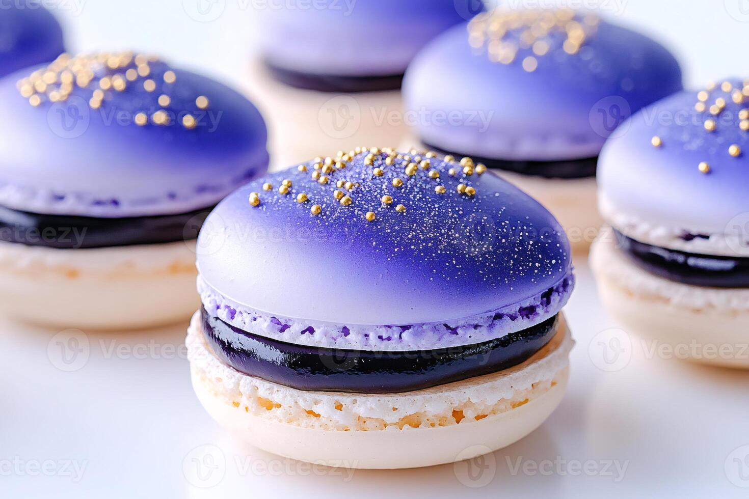 Delicious purple macarons with golden sprinkles sitting on white background. photo