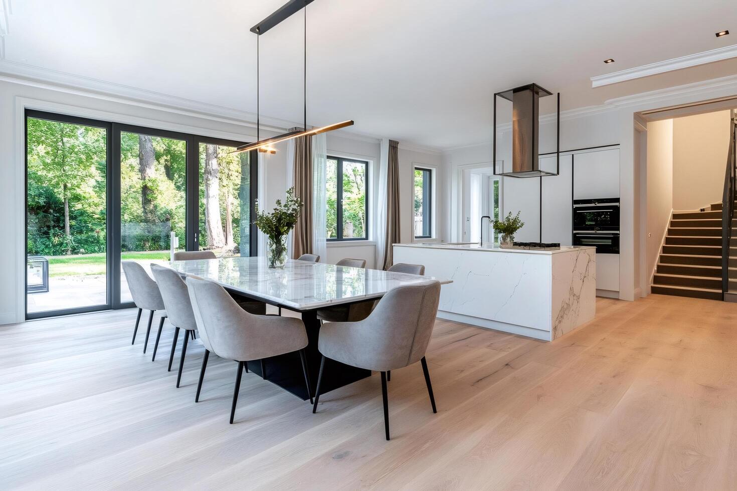 Modern open space kitchen and dining room showing garden view photo