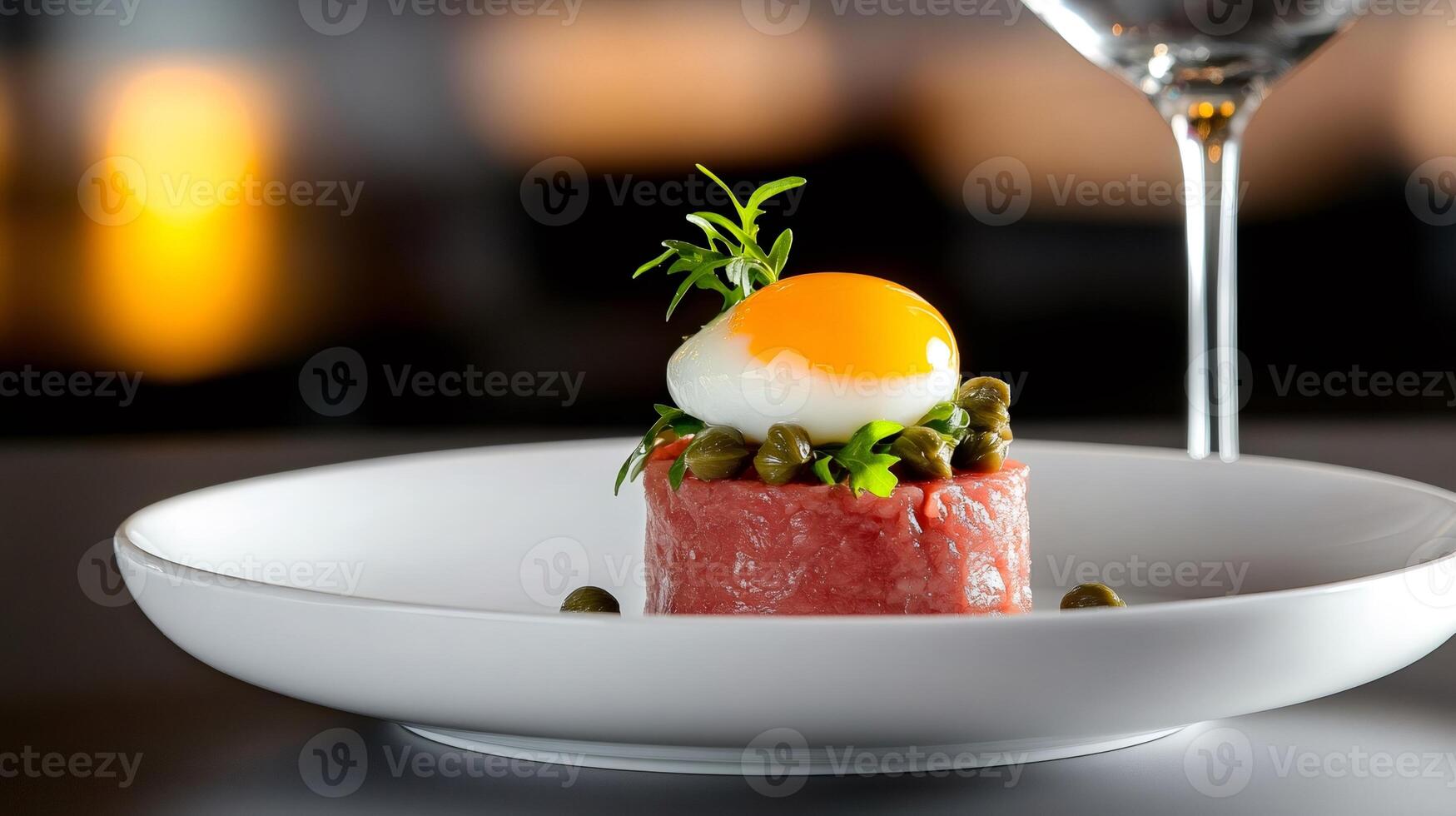 Beef tartare with egg yolk, capers and arugula, served on white plate photo