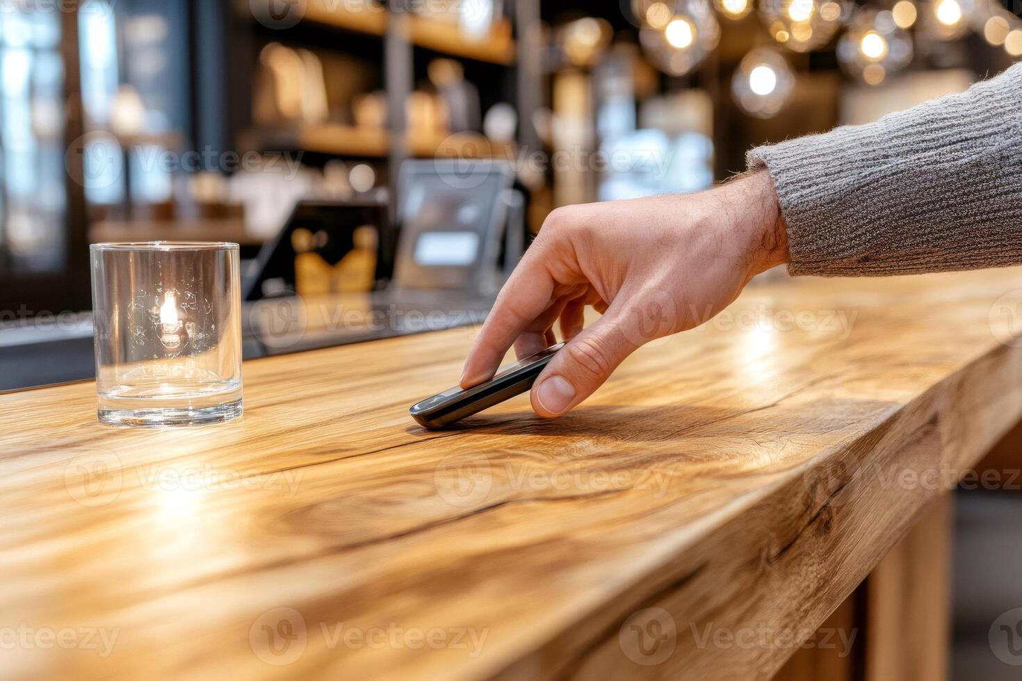Customer leaving digital tip jar with mobile phone in cafe photo