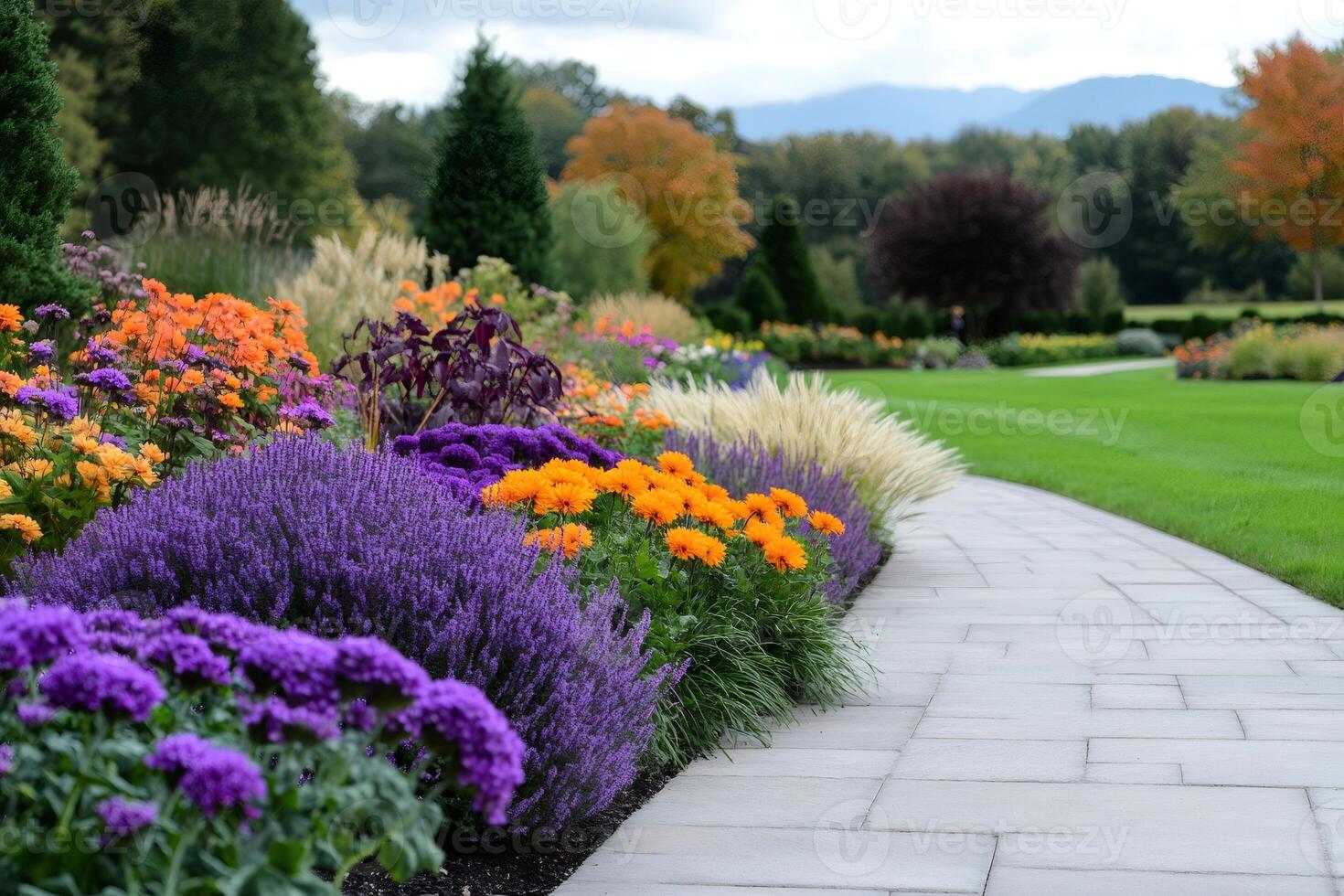 Colorful flowerbed bordering paved path in manicured garden photo