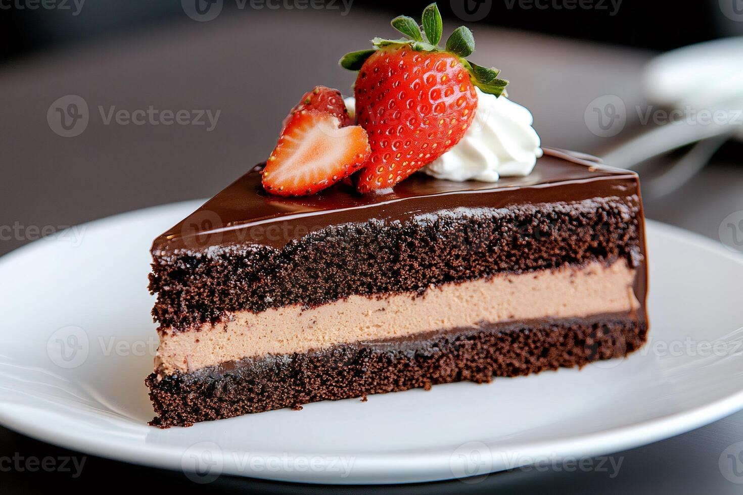 Delicious slice of chocolate cake with strawberries and whipped cream topping photo