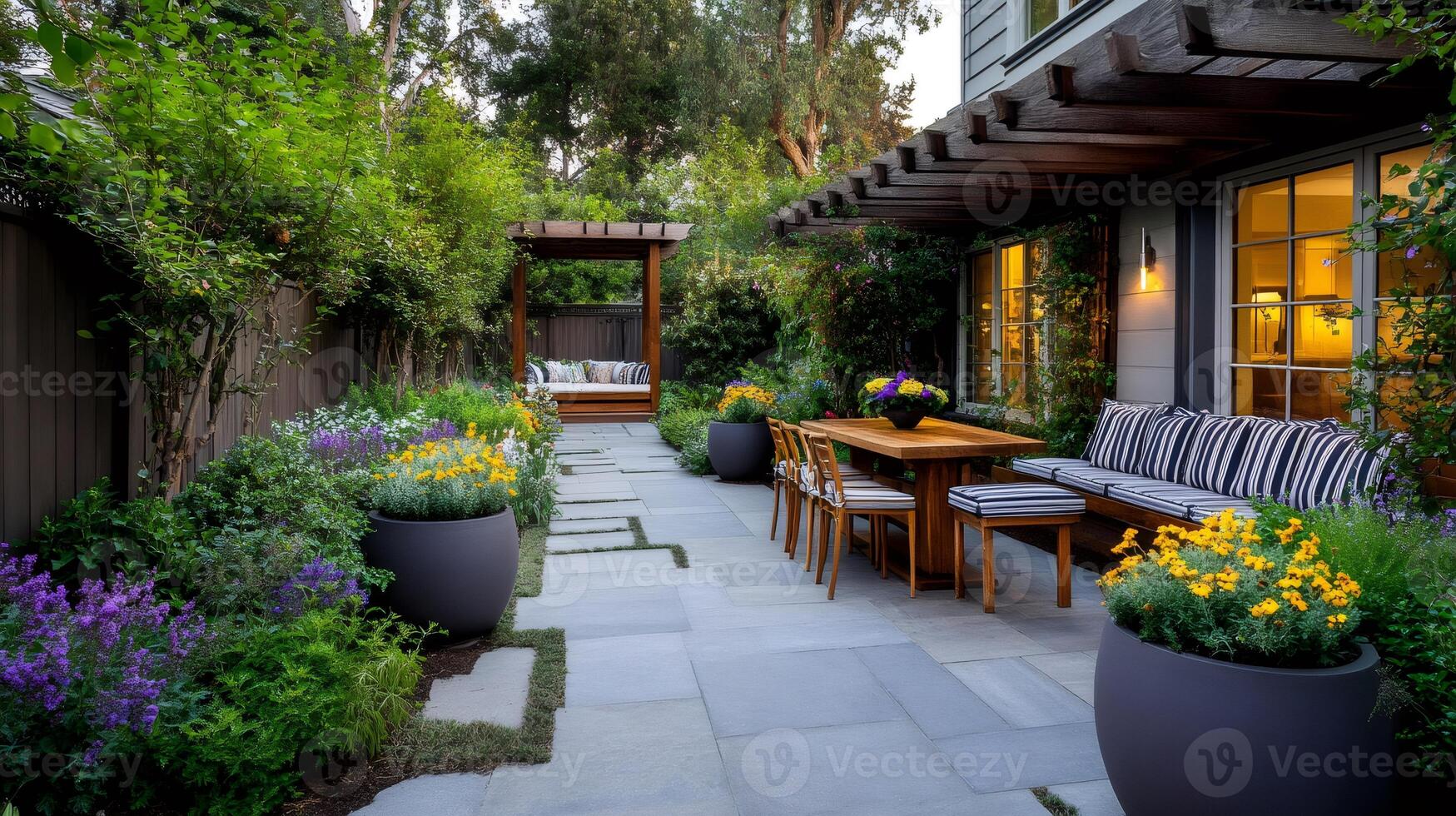Beautiful backyard patio with pergola, wooden table and blooming flowers photo