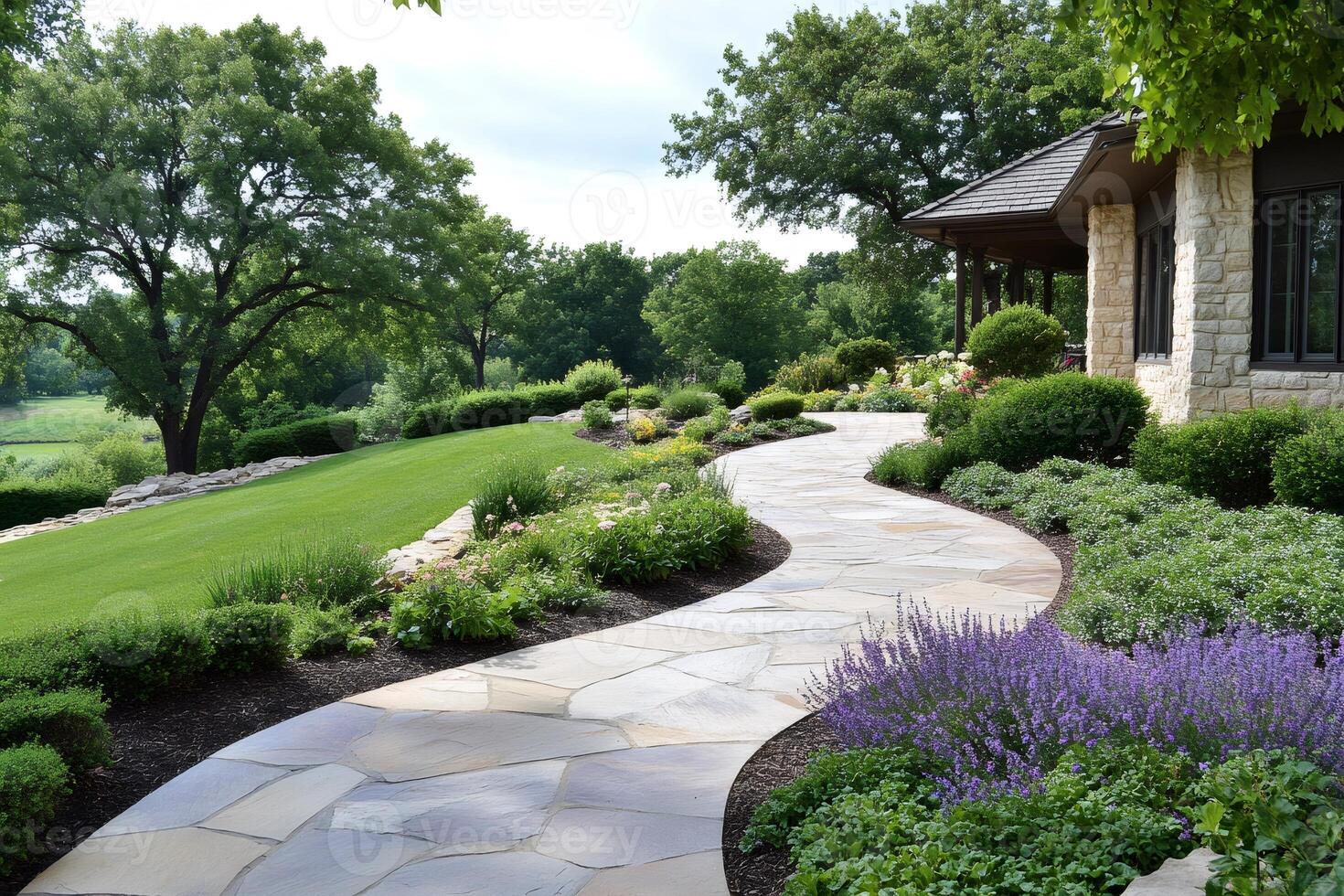 Winding flagstone path leading to luxury home in beautiful landscape photo