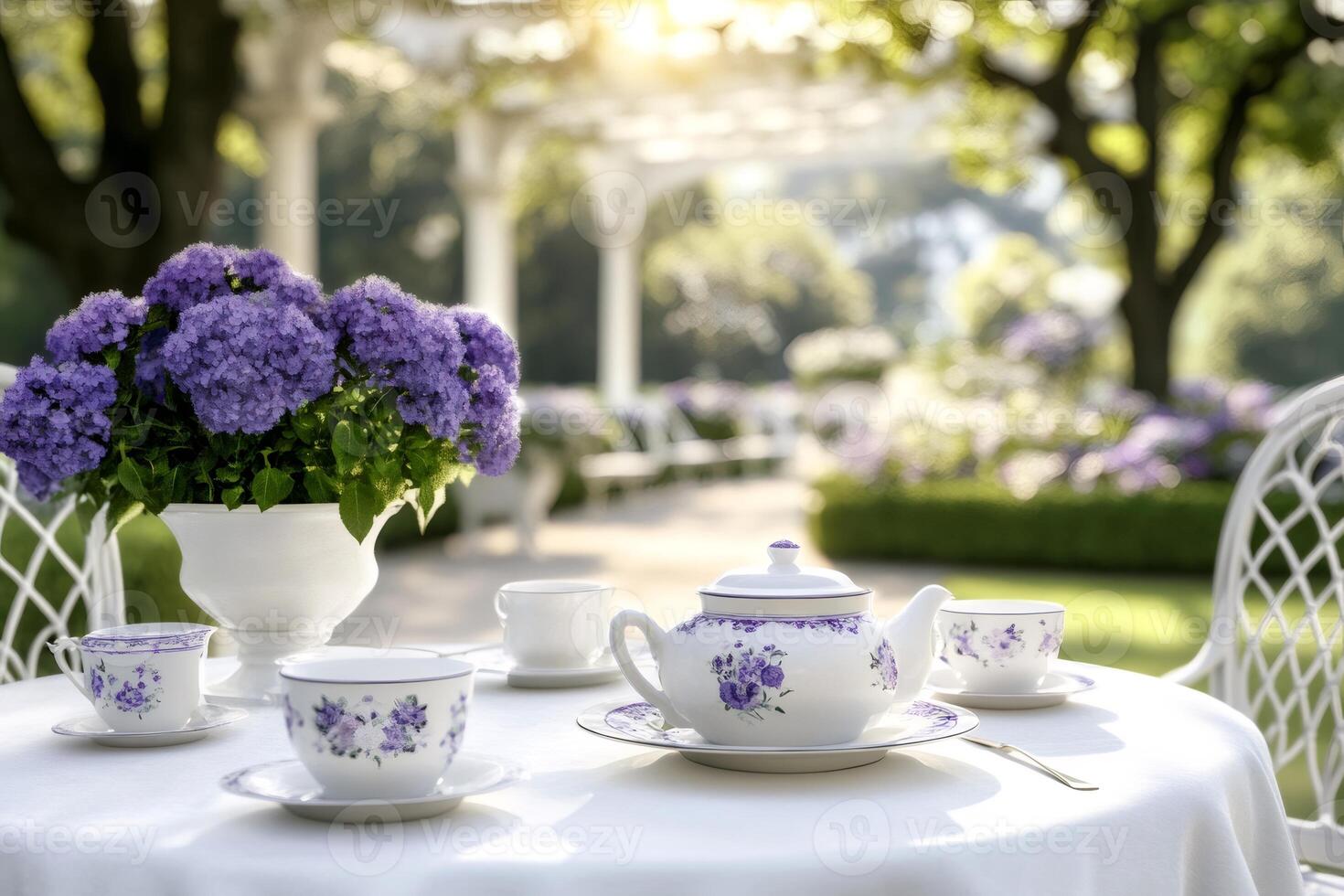 Elegant tea set and purple flowers decorating a table in a luxurious garden photo