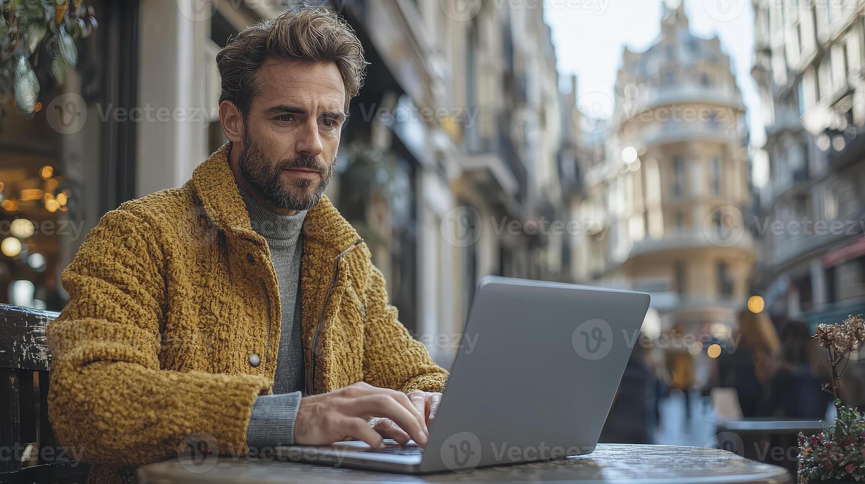 Businessman Working on Laptop Outdoors in Urban Setting with Modern Architecture photo