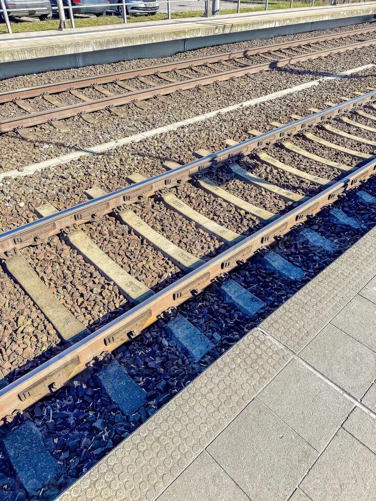 Empty Train Tracks at Station, Gravel and Concrete, Public Transportation Infrastructure. High quality photo