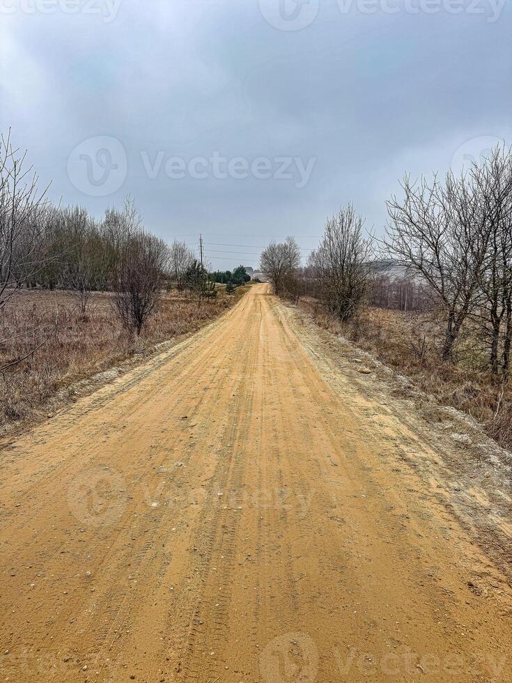 Empty Dirt Road Through Rural Landscape, Cloudy Sky, Natural Scenery, Travel, Remote Location. High quality photo