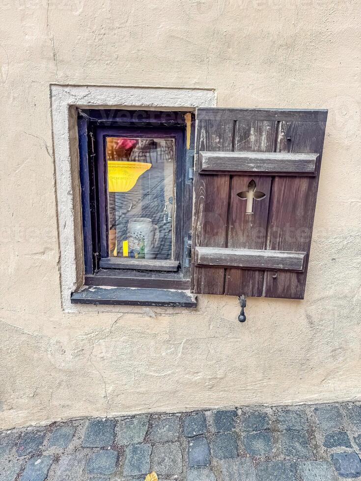 Old small Window with Wooden Shutter Open, Stone Wall, Historic Architecture, Street View. High quality photo